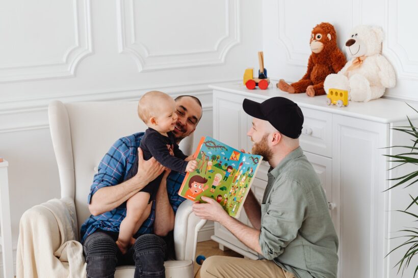 Two Men Having Fun With A Baby